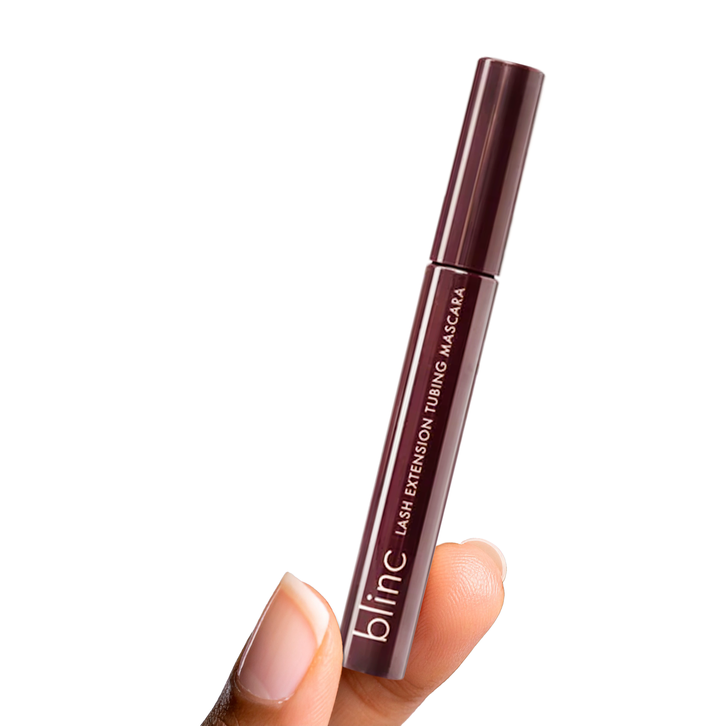 Innovate the Label tubing mascara for sensitive eyes held in hand with dark brown packaging
