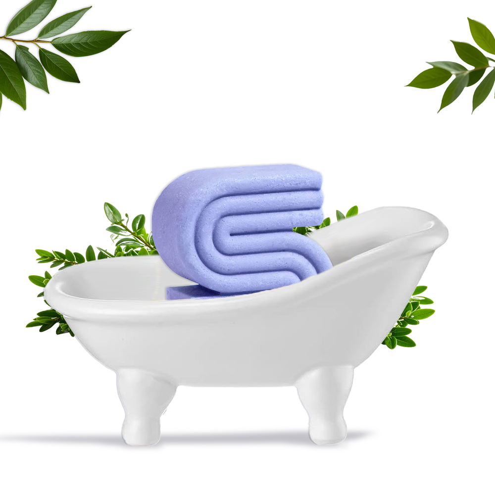 Innovate Label white ceramic clawfoot soap dish holding a purple beauty bar with green leaves bathtub soap dish for beauty bars