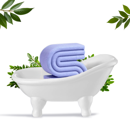 Innovate Label white ceramic clawfoot soap dish holding a purple beauty bar with green leaves bathtub soap dish for beauty bars