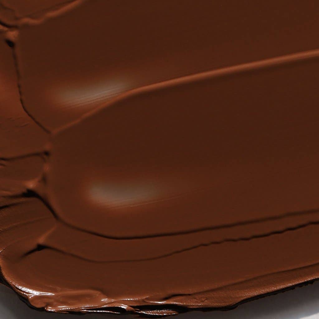Smooth rich brown cream bronzer for face texture providing natural sun-kissed glow