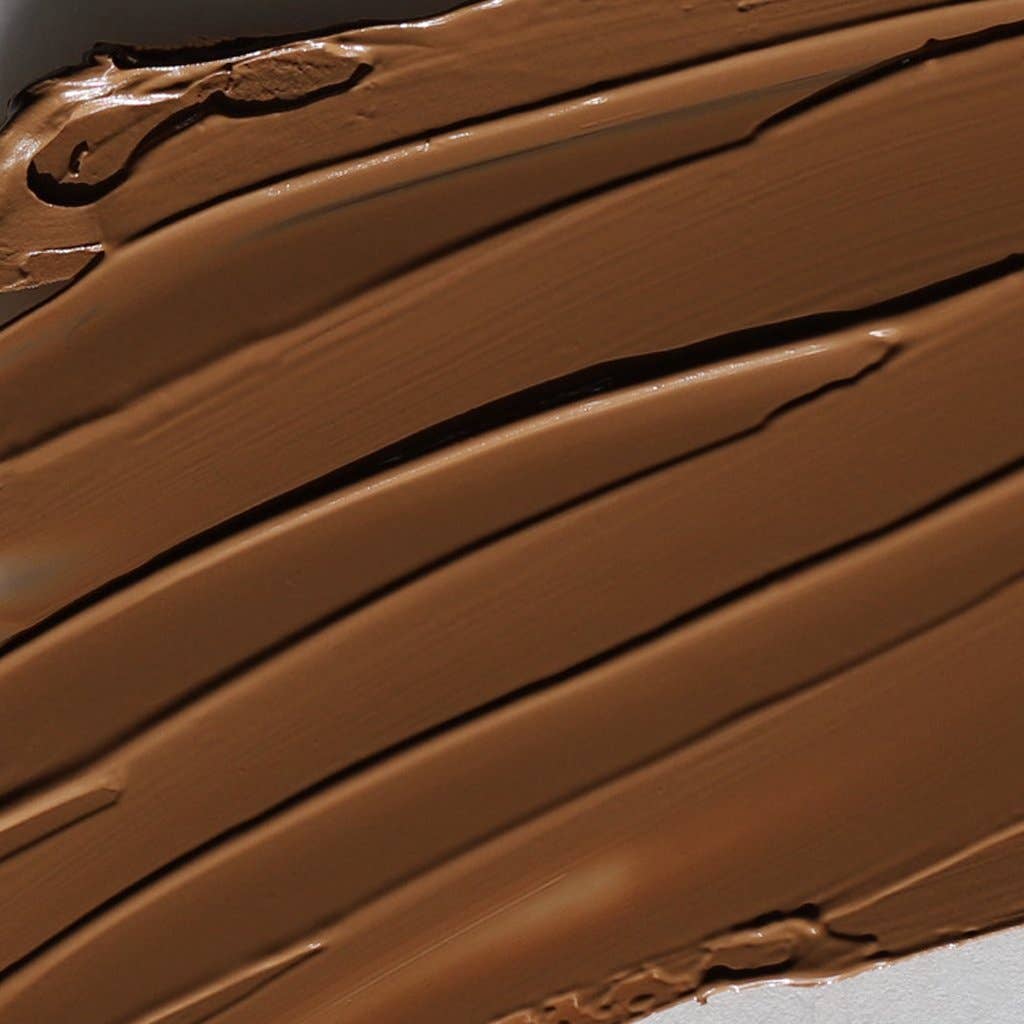Close-up texture of Innovate the Label cream bronzer for face in rich brown shade