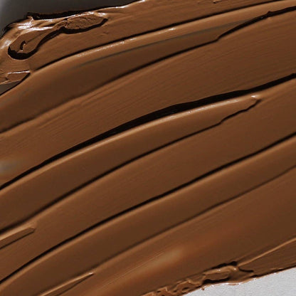 Close-up texture of Innovate the Label cream bronzer for face in rich brown shade