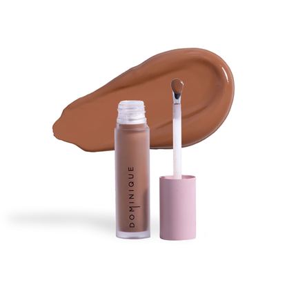 Dominique Cosmetics concealer by Innovate the Label in a brown shade with applicator wand and swatch