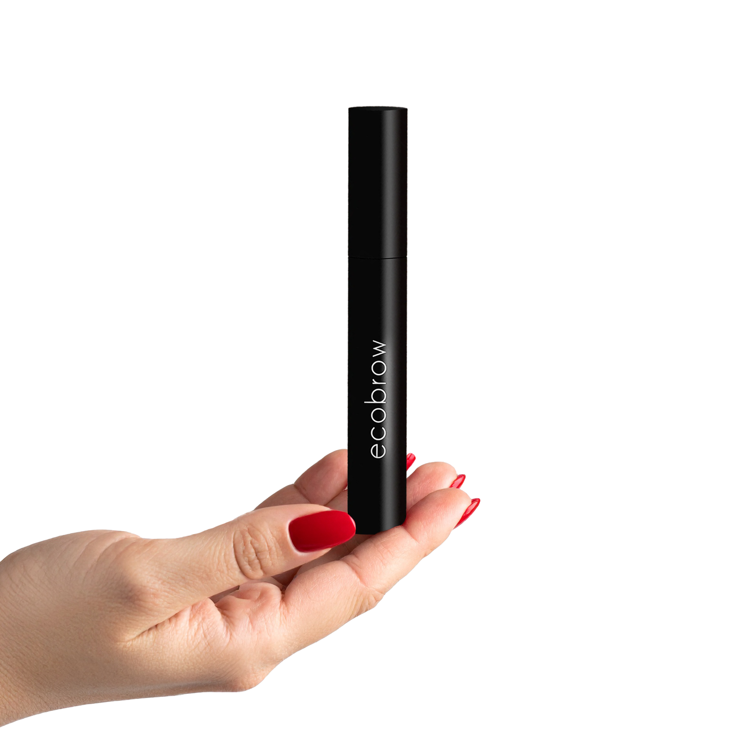 Hand holding Innovate the Label clear eyebrow gel in sleek black tube with red nail polish