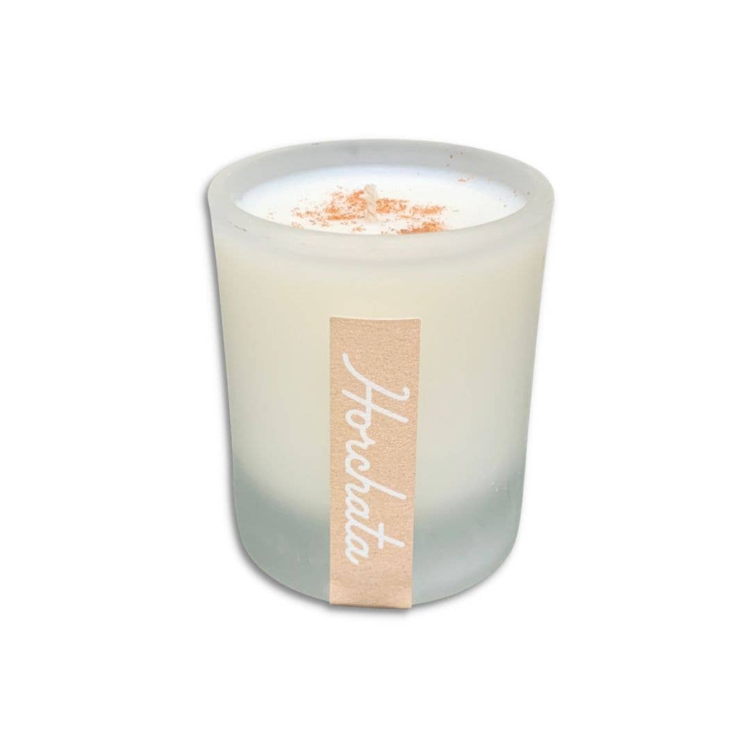 SIN-MIN horchata candle in frosted glass with cinnamon topping and beige label