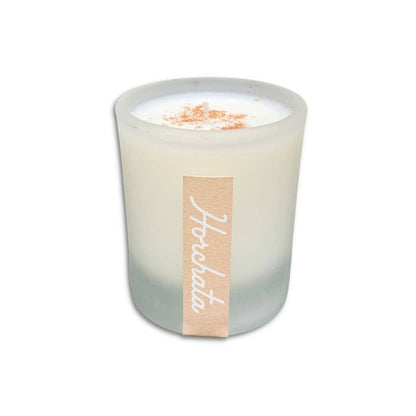 SIN-MIN horchata candle in frosted glass with cinnamon topping and beige label
