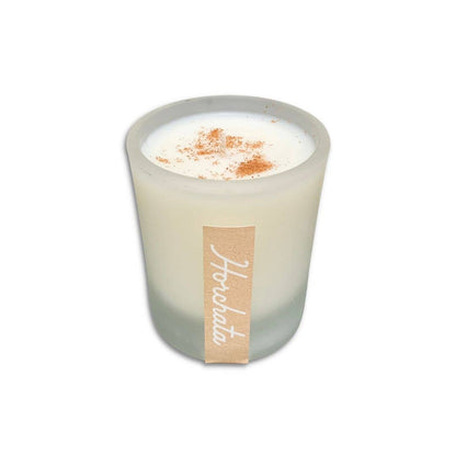 SIN-MIN horchata candle in frosted glass with cinnamon topping on white wax