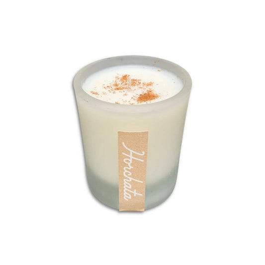 SIN-MIN horchata candle in frosted glass with cinnamon topping on white wax