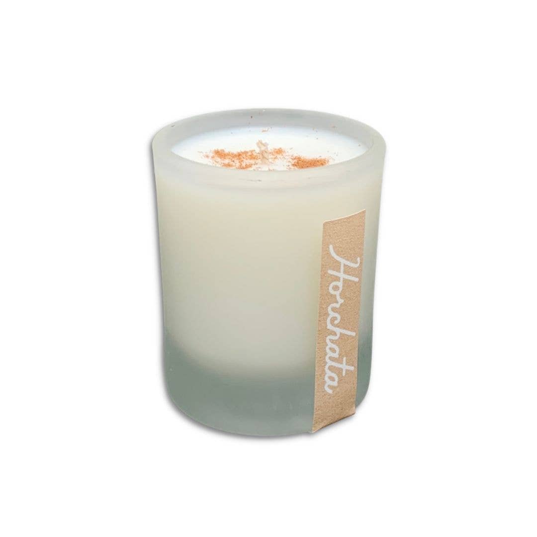 SIN-MIN horchata candle in frosted glass holder with creamy white wax and cinnamon topping