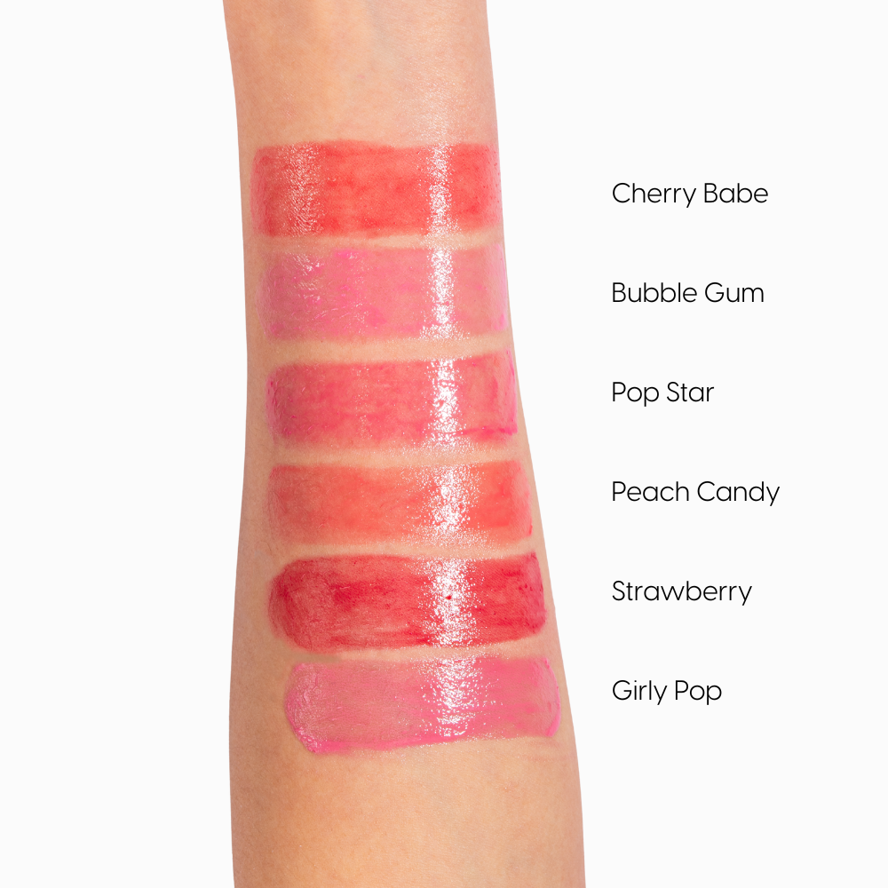 Kara Beauty strawberry gloss stick swatches on arm showing six glossy pink and red lip shades with labels