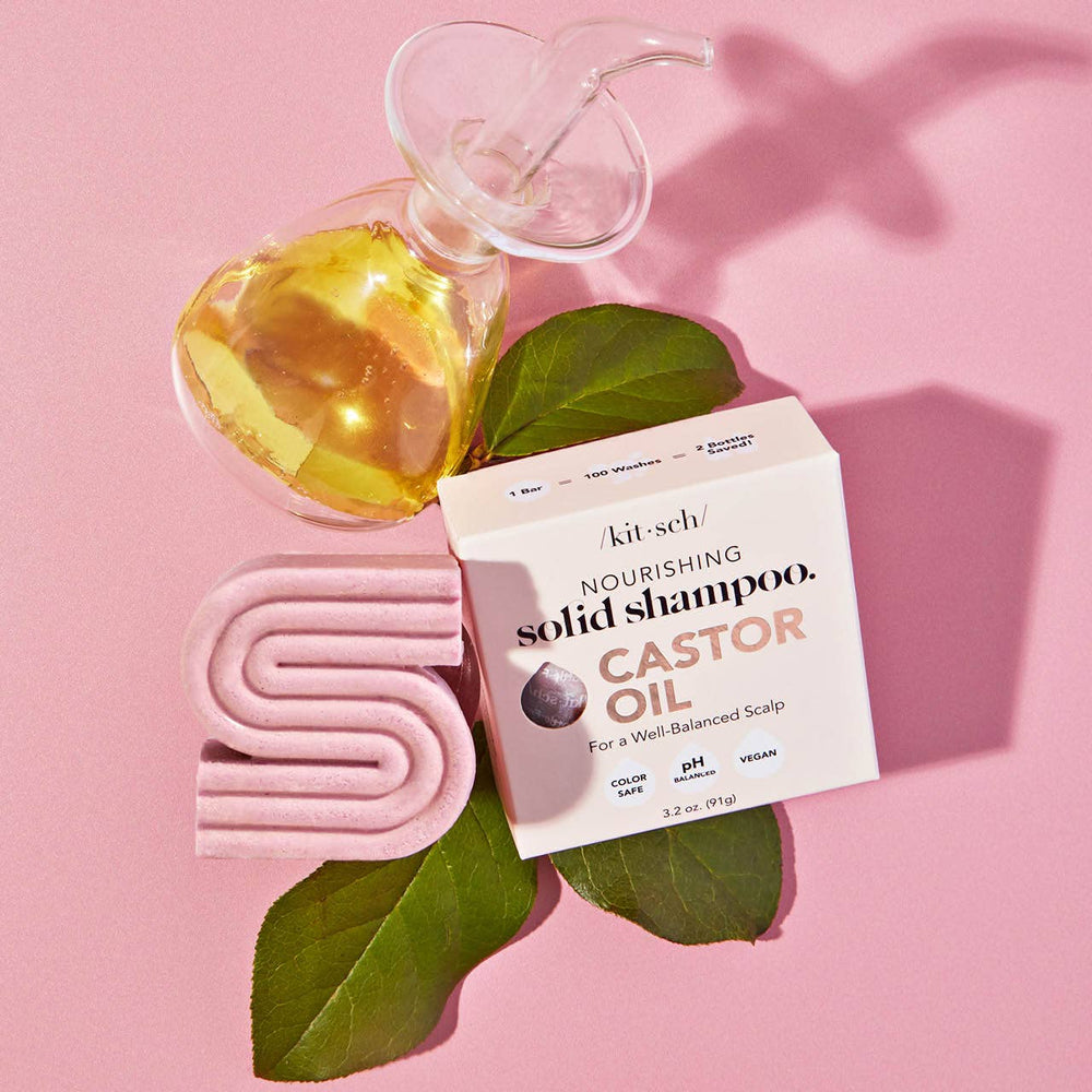 Innovate the Label castor oil shampoo bar solid shampoo with natural castor oil and green leaves on pink background