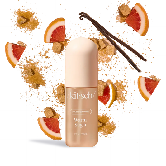 Innovate the Label warm sugar hair perfume bottle surrounded by vanilla pods grapefruit slices and brown sugar