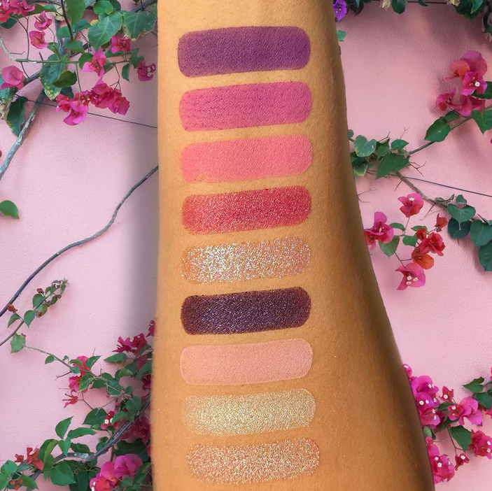 Swatches of Leyva Beauty eyeshadow palette by Innovate the Label showing vibrant pink, purple, and glitter shades on arm