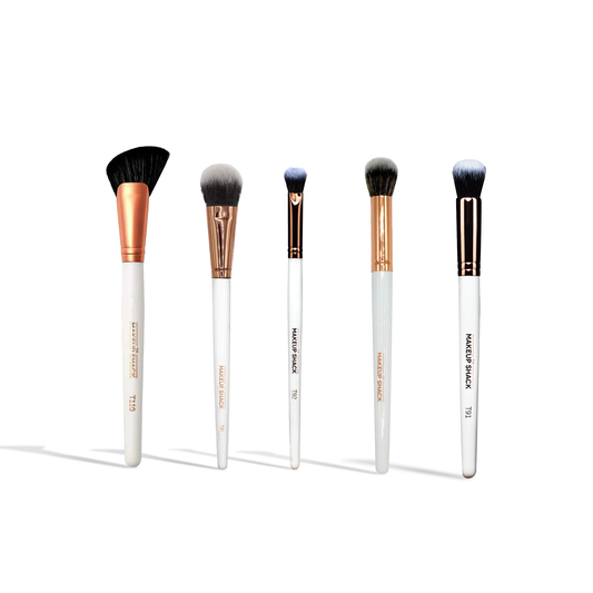 Innovate the Label essential face brush set with five white-handled makeup brushes with rose gold and black ferrules