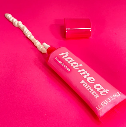 Innovate the Label illuminating face primer tube with a cream applicator on bright pink background