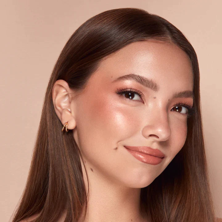 Close-up of a woman wearing Alamar liquid blush by Innovate the Label with natural glowy makeup